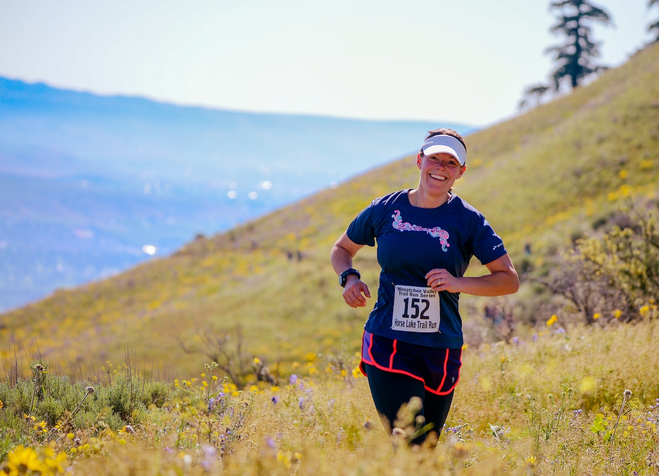 A woman runs in a field.